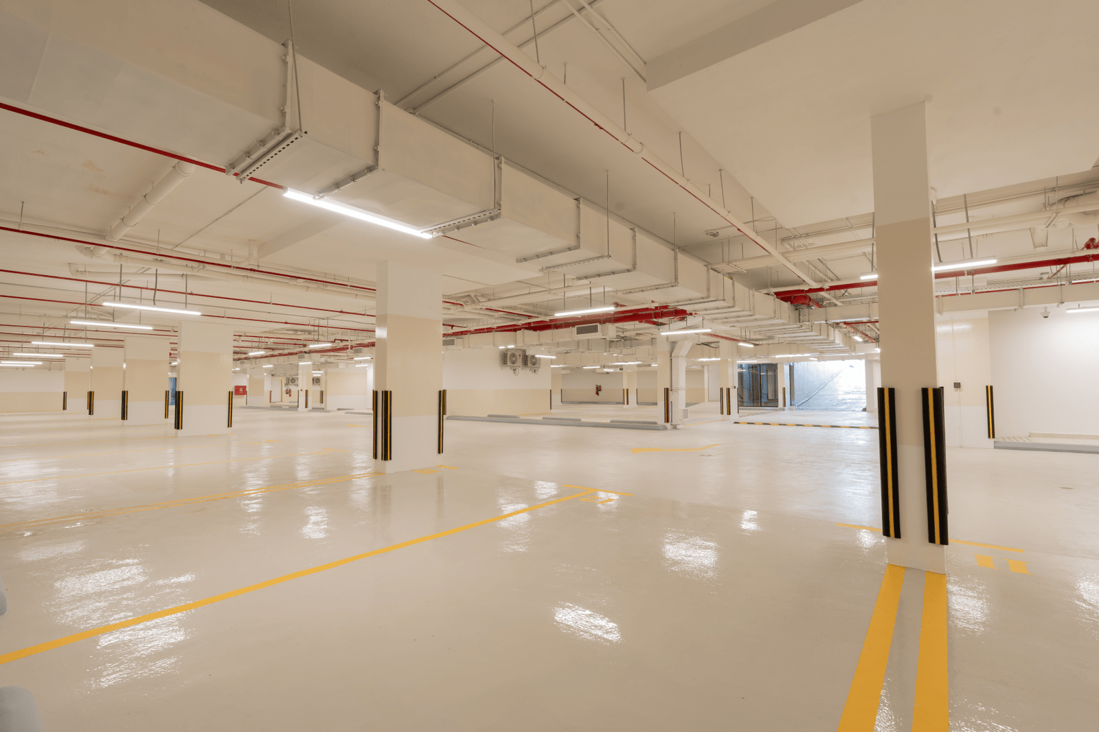 Clean, well-lit underground parking with marked spaces.